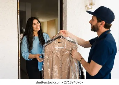 delivery-person-giving-cleaned-garments-260nw-2713940907 Sự chuyên nghiệp và đúng hẹn của nhân viên giao nhận là tiêu chí quan trọng hàng đầu